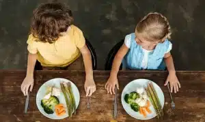 A colorful plate of healthy food including fruits, vegetables, and whole grains, showcasing a balanced meal for kids.